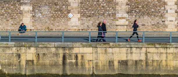 Bearded mid adult man standing by the bridge fence and checking time on his watch, short city break, enjoying seasonal vacation