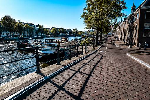 Downward Bridge View Of Beautiful Walkway Near Canal And Boats In Amsterdam, The Netherlands