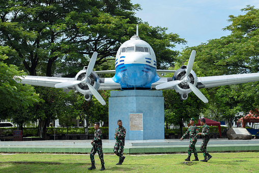 Indonesian soldiers pass in front of the Seulawah 001 Airplane Monument at Blang Padang Field after attending the ceremony to commemorate the 77th TNI Anniversary on Wednesday, October 5, 2022.