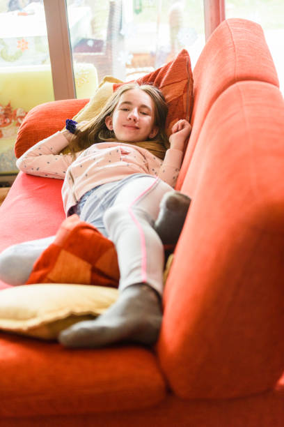 istock Cute Girl Napping on Couch 1430730579