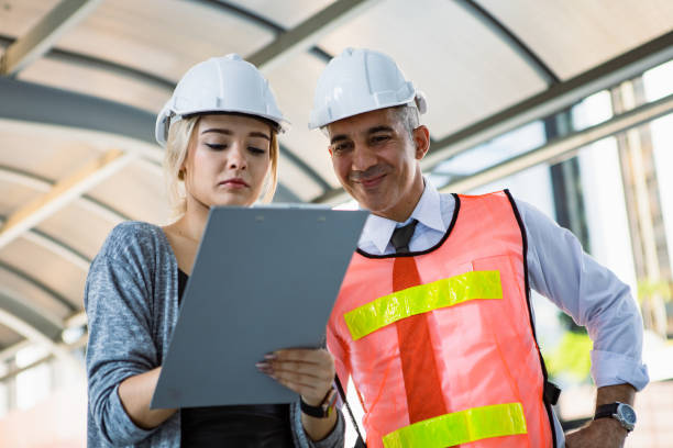 istock Two engineers check the work through a checklist at the job site. 1430731344