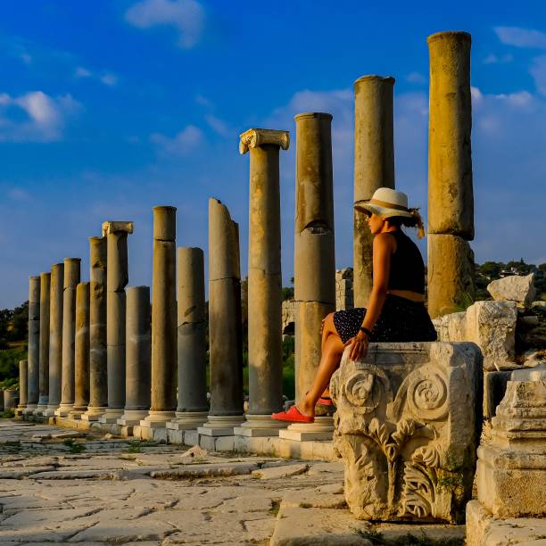 istock A woman sitting in a historical ruin and historical columns 1430732014