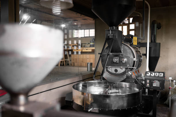 Big black clean coffee roaster machine sitting inside of a room