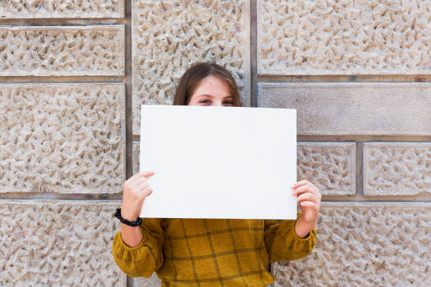 istock Cheerful child holding a paper for your text 1430732925