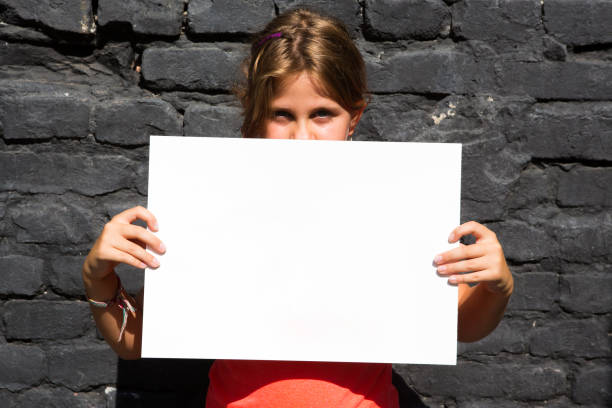 istock Child holding a sign in front of her face 1430734394