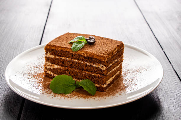istock Tiramisu dessert decorated with mint on white plate. 1430734513