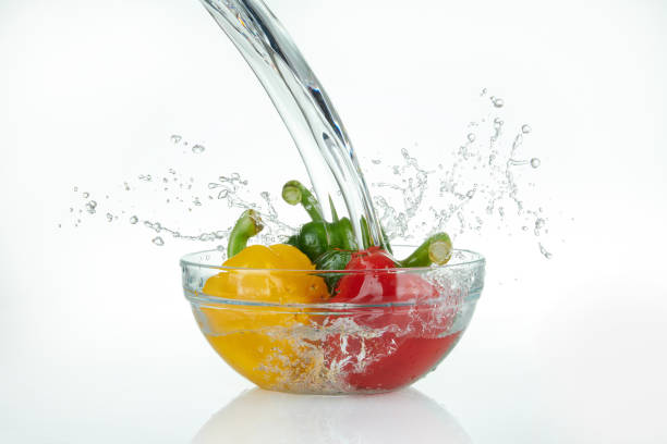 istock waterfall pouring onto a glass bowl with peppers. 1430735831