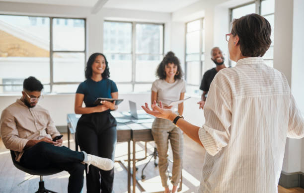 istock Presentation, communication and business leader with team in discussion, conversation or talking about marketing strategy. Meeting, collaboration and employee writing notes for company success goal 1430735957