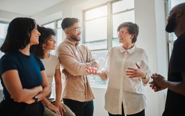 istock Teamwork, planning and communication with a creative designer and her team talking about an idea during a meeting. Collaboration, strategy and mission with a female employee explaining her vision 1430735998