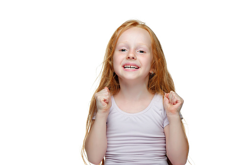 Happy successful little girl with red hair