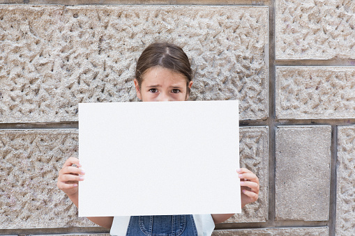 child holding a empty paper