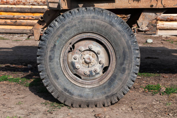 Old rusty truck wheel close up photo, front view