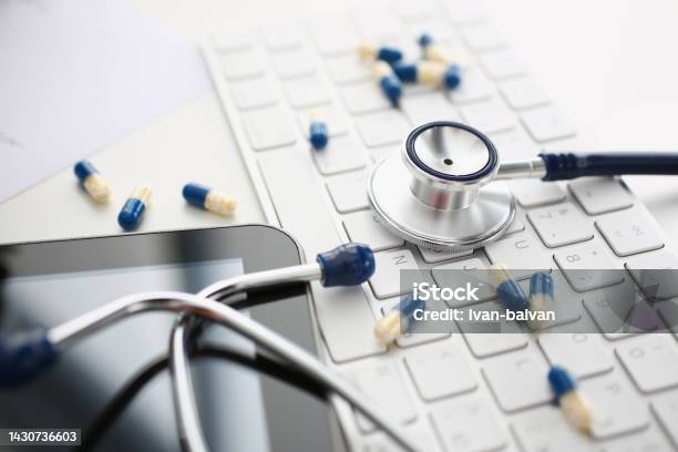 Tablets And Stethoscope On Computer Keyboard Closeup Stock Photo - Download Image Now