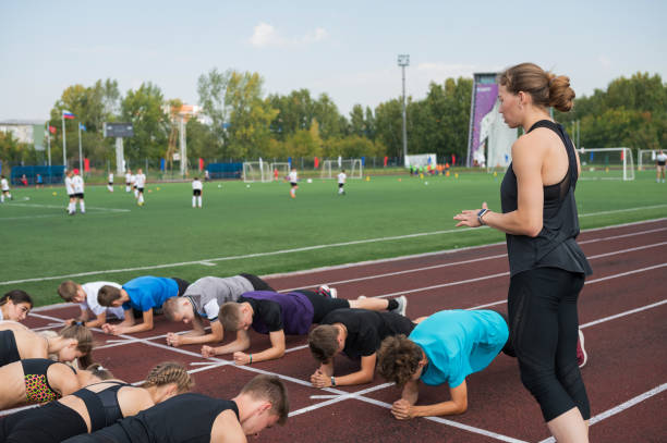 istock Female coach and group of children conducts a training session 1430736866