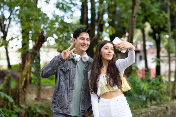 istock Friends taking a picture in the park 1430739180