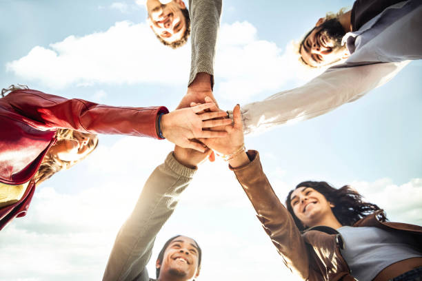 istock Multiracial happy young people stacking hands outside - Diverse friends unity togetherness in volunteer community - Concept about university, relationship, creative, youth and human resources 1430739315