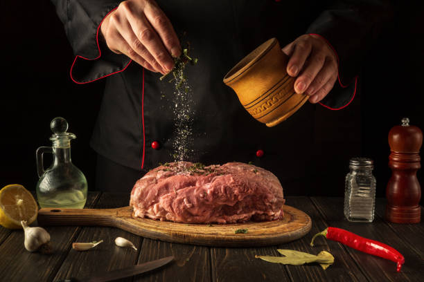 istock Adding scias to raw meat for a delicious flavor before preparing a national dish. Chef while cooking in the kitchen. Menu concept for hotel. 1430739834