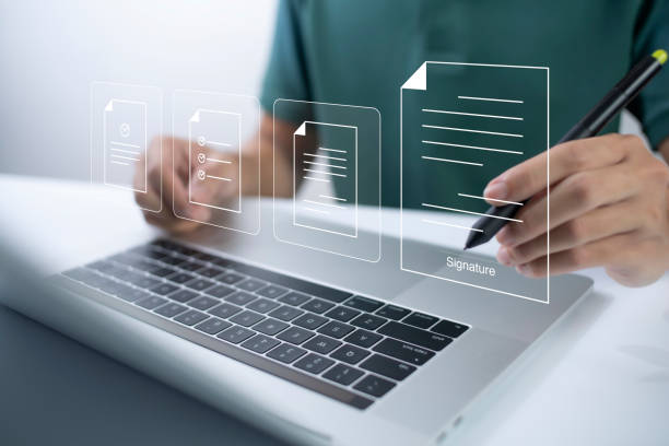 istock Businessman, work from home, handling documents, E-signing, signing digital contracts electronic signing electronic signature through internet technology document data management smart contract 1430740296