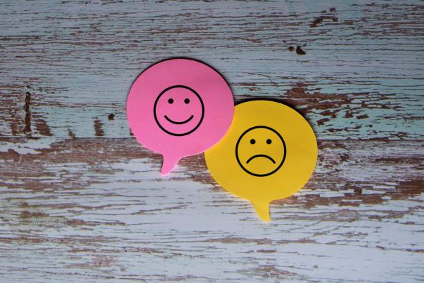 Speech bubble with smile and sad face. stock photo