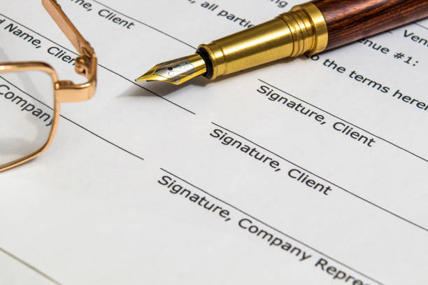 istock Contract paper between two parties and a pen for signing 1430744562