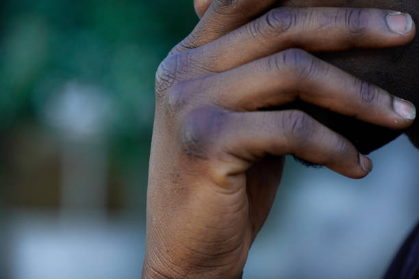 istock Foreground of unrecognizable portrait with a black hand. 1430744601