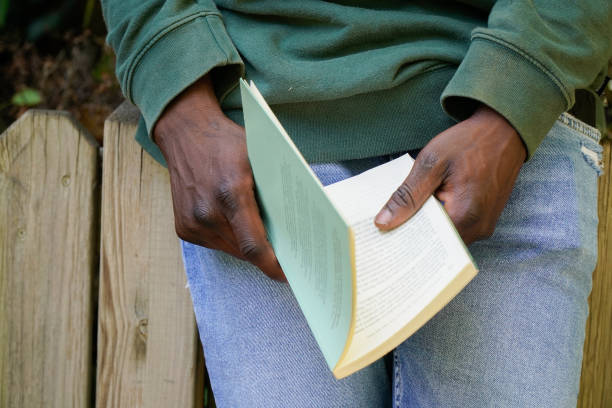 African person reading a book. Black man education