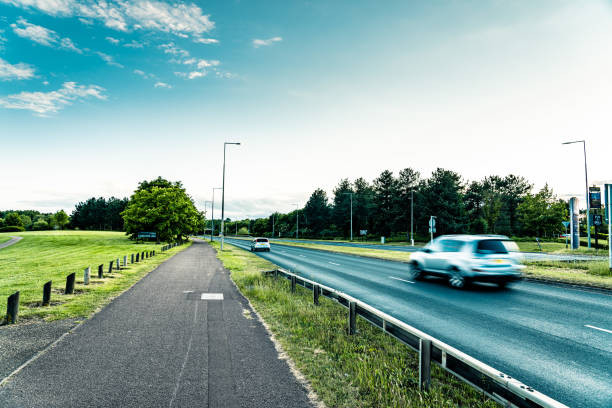 A white car and a white van with motion blur travelling