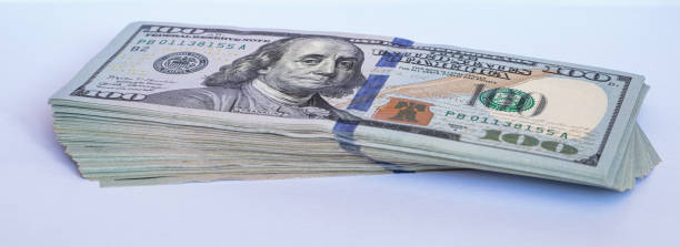 istock Pile of 100 dollar banknotes on white background 1430750978