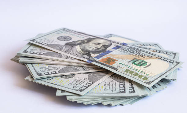 istock Pile of 100 dollar banknotes on white background 1430752786