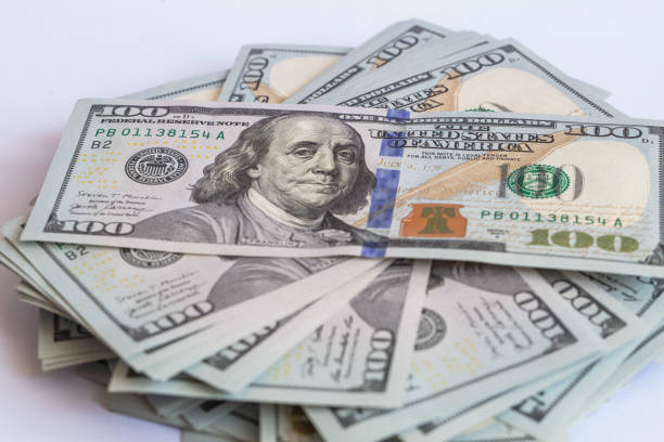 istock Pile of 100 dollar banknotes on white background 1430753028
