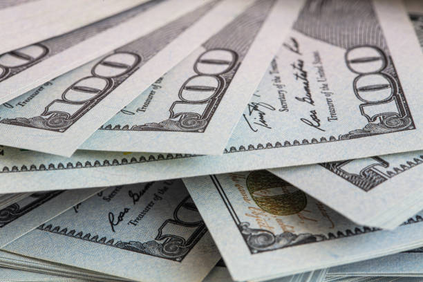 istock Pile of 100 dollar banknotes on white background 1430753685