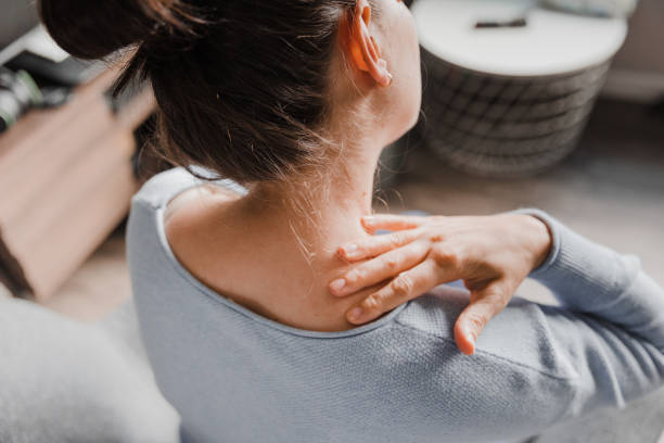Woman massaging her stiff neck