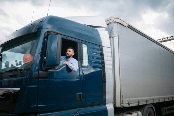 istock Truck driver sitting in his truck 1430761908