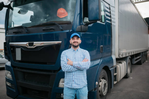 istock Confident trucker standing in front of his truck 1430761937