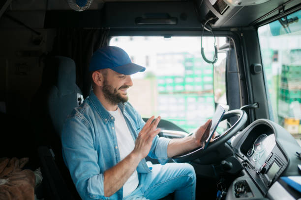 istock Trucker using his phone to make a video call while on the road 1430761998