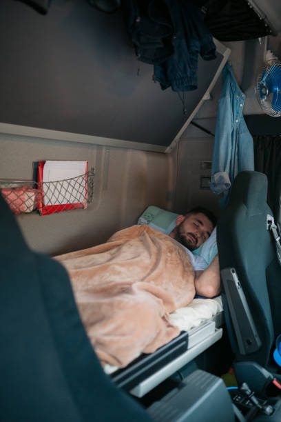istock Trucker sleeping in the truck's sleeping cabin 1430762543