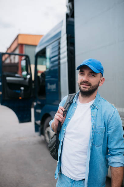 istock Confident trucker standing in front of his truck 1430762693