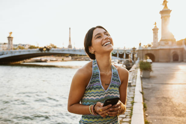 istock Young woman using smart phone outdoors and popular mobile apps for chat or social media 1430764521