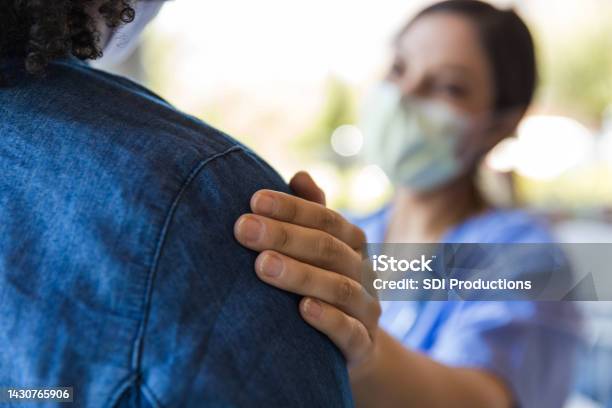 Doctor Comforts A Patient Stock Photo - Download Image Now - Patient, Empathy, Doctor