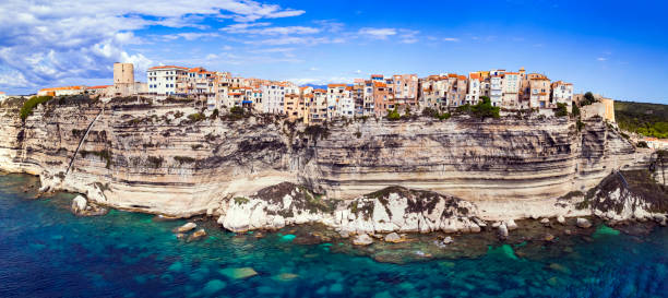 Bonifaccio - splendid coastal town  in south of Corsica island, aerial drone view of houses hanging over rocks. France Bonifaccio - splendid coastal town  in south of Corsica island, aerial drone view of houses hanging over rocks. France bonifacio stock pictures, royalty-free photos & images