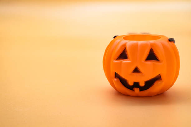 istock close-up plastic halloween pumpkin on orange background 1430768462
