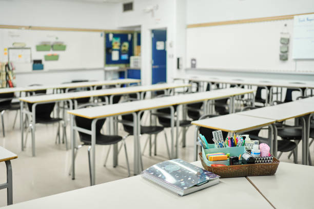 istock Chairs and desks in a bright school classroom 1430768763