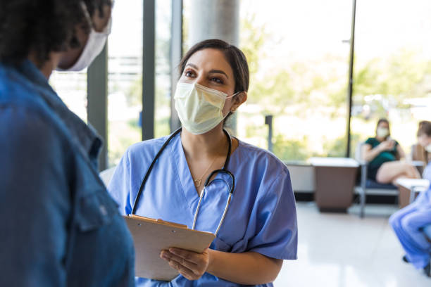istock Doctor holds clipboard and talks to patient 1430769002