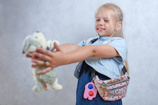 istock Child playing with a plush toy dog 1430773831