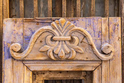 Old Cairo, Cairo, Egypt. Carved decoration on a weathered antique door.