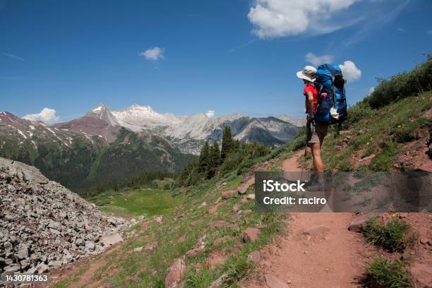 Woman Backpacker On Buckskin Pass Four Pass Backpacking Trip Around The Maroon Bells Snowmass Mountain In The Distance Aspen Colorado Stock Photo - Download Image Now