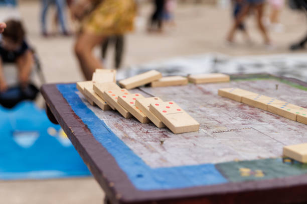 Boy playing with a wooden dominoes outside, in a medieval market
