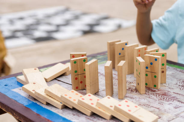 istock Boy playing with a wooden dominoes outside 1430781389