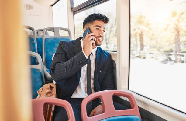istock Phone, travel or communication with a business man talking and networking on a bus, public transport and commuting in a city. 5g mobile technology with a young worker having a conversation on a call 1430785152
