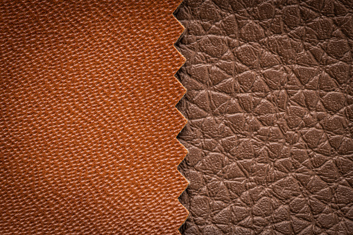 Brown artificial or synthetic leather background with neat texture and copy space, colorful fabric sample with leather-like finish aimed for upholstery, fashion, sewing or footwear projects